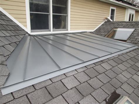 sheets of metal roofing|pitched metal covering roof.